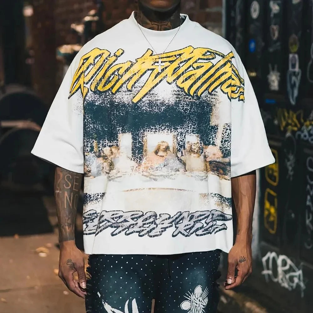 Person wearing a white t-shirt with a graphic design and text, standing against a blurred background.